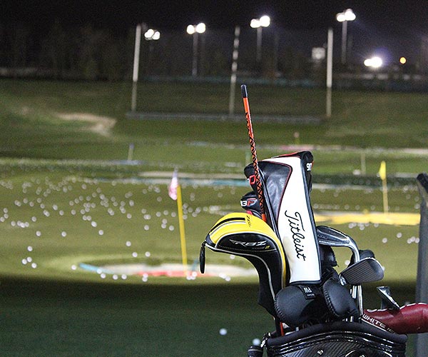 Night scene with lit golf driving stations